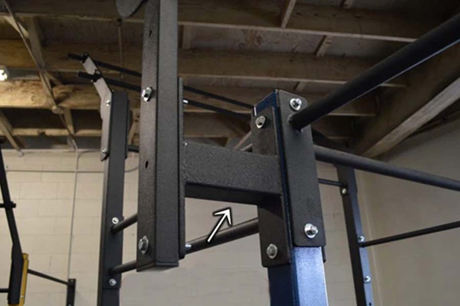 Black steel wall-mounted attachment bracket with bolts and mounting hardware on concrete pillar