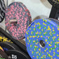Colorful rubber bumper plates with fleck pattern design, including pink and gray plate with metal center collar and blue plat