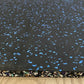 Black rubber gym flooring tile with blue fleck pattern and colorful speckled border, shown on wood floor