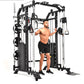 Black and white multi-functional home gym cable crossover machine with smith bar, used by shirtless male model in black short
