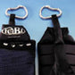 Black Drabo speaker keychain with carabiner clip, shown front and back views against blue background