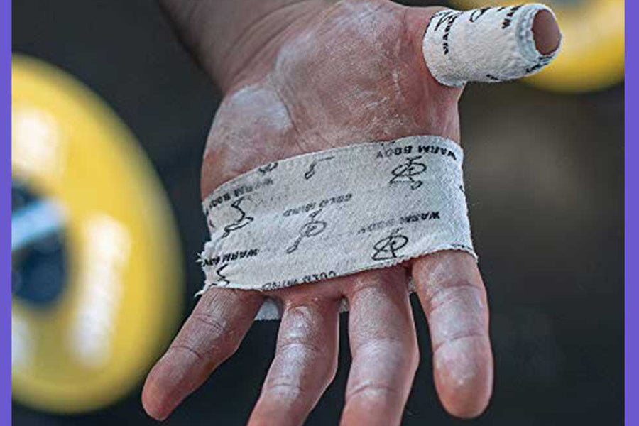 White athletic tape with black printed pattern wrapped around hand and finger, worn during activity