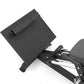Black compact leg press machine with textured footplate and adjustable articulating arm on white background