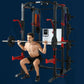 Shirtless man performing barbell squat in black and red cage rig system with weight plates on dark blue background
