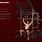 Black and red metal squat rack cage with pull-up bar, weight plate pegs, and adjustable bench, shown with shirtless male mode