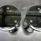Pair of chrome dumbbell end caps with "18" markings and adjustment holes, displayed on gray surface