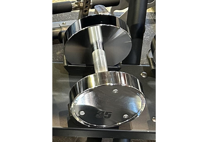 Pair of chrome dumbbells with polished steel finish and black grip handles, stacked vertically on black stand