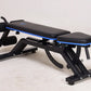 Black and blue weight bench with leg extension attachment and adjustable decline position on white background