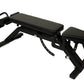 Black adjustable weight bench with padded seat and backrest, leg extension attachment, and foot platform on white background