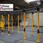 Warrior Commercial Pro Rig System with yellow posts and black horizontal bars in gym setting on gray flooring