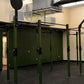 Warrior Commercial Pro Rig System with olive green steel frame, black pull-up bars, and perforated uprights in gym setting