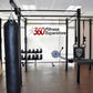 Black multi-functional crossfit rig system with pull-up bars, heavy bag hanging attachment, and training accessories in fitne