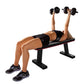 Woman performing dumbbell chest press on black flat weight bench with red trim