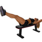 Woman performing leg exercise on black flat weight bench with pink trim, wearing black sports bra and shorts with gray athlet
