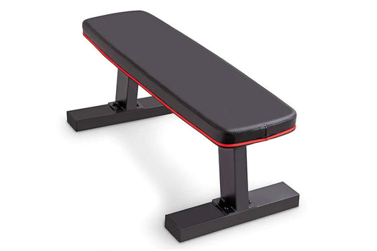 Black and red flat weight bench with padded seat, adjustable backrest, and sturdy black metal frame on white background