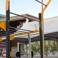 Warrior Flying Pull Up Attachment with yellow and black metal frame mounted on outdoor training rig