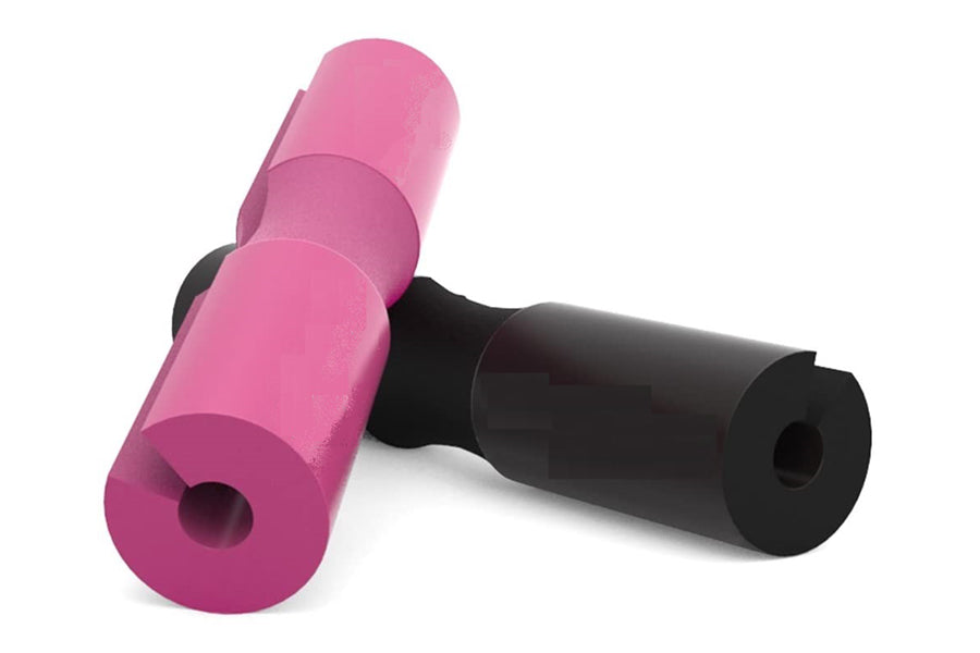 Pink and black foam squat pad with cylindrical cushioning and connector joint on white background