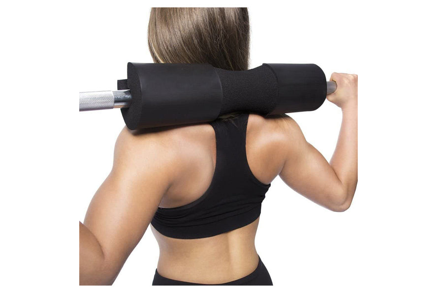 Black foam barbell squat pad with silver bar, worn by model on shoulders during weighted exercise