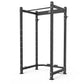 Black steel power rack with adjustable height uprights, horizontal top beam, and safety bars on white background