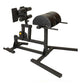 Black leg press and glute-ham developer machine with padded seat and leg attachment, on white background