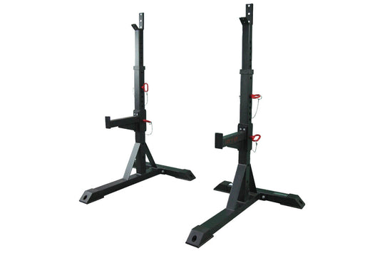 Pair of black steel squat stands with adjustable J-cups, red safety pins, and wide foot bases, shown on white background
