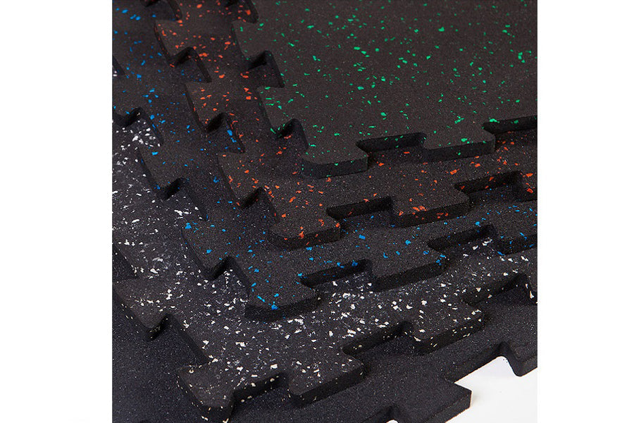 Black interlocking rubber gym floor tile with white, blue, orange and green speckles, shown in flat lay view
