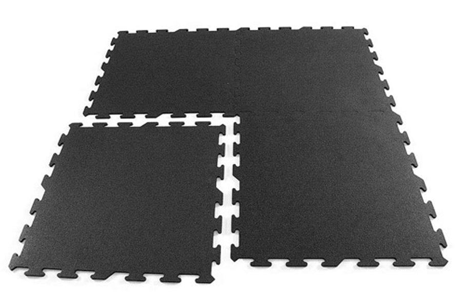Black interlocking rubber gym flooring tiles with speckled texture and puzzle-piece edges on white background