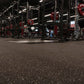 Warrior Interlocking Rubber Gym Flooring Tiles in speckled black with red and white flecks, installed in commercial gym space