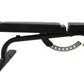 Black weight bench with padded seat and backrest, adjustable leg extension, metal frame on white background