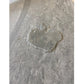 Wet footprint impression on beige interlocking marble gym tile flooring in pine finish