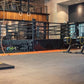 Warrior Marble Interlocking Gym Tile Flooring in pine installed in modern fitness studio with training equipment and black ra