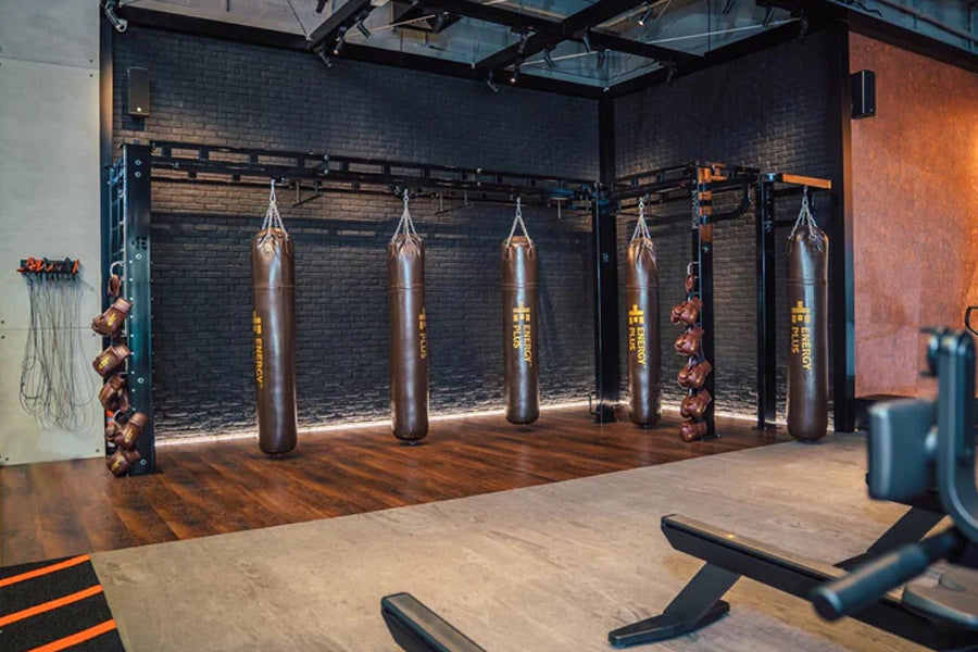 Warrior Marble Interlocking Gym Tile Flooring in pine color installed in boxing gym with heavy bags and equipment