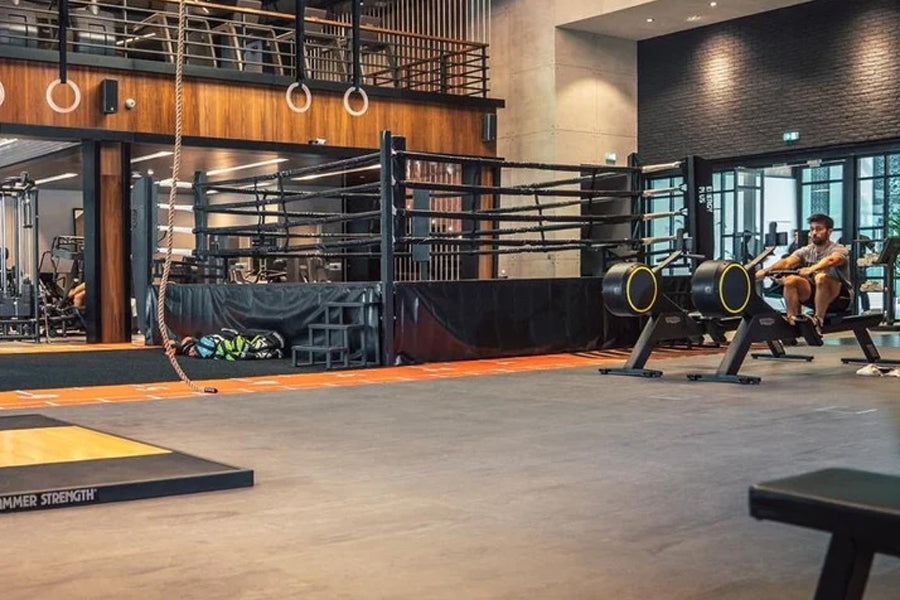 Warrior Marble Interlocking Gym Tile Flooring in sand color installed in modern gym space with equipment