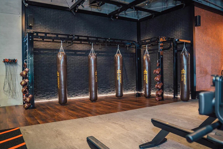 Warrior Marble Interlocking Gym Tile Flooring in sand color installed in boxing gym with heavy bags
