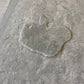 Stone grey interlocking gym tile with embossed warrior head design, shown on flat surface