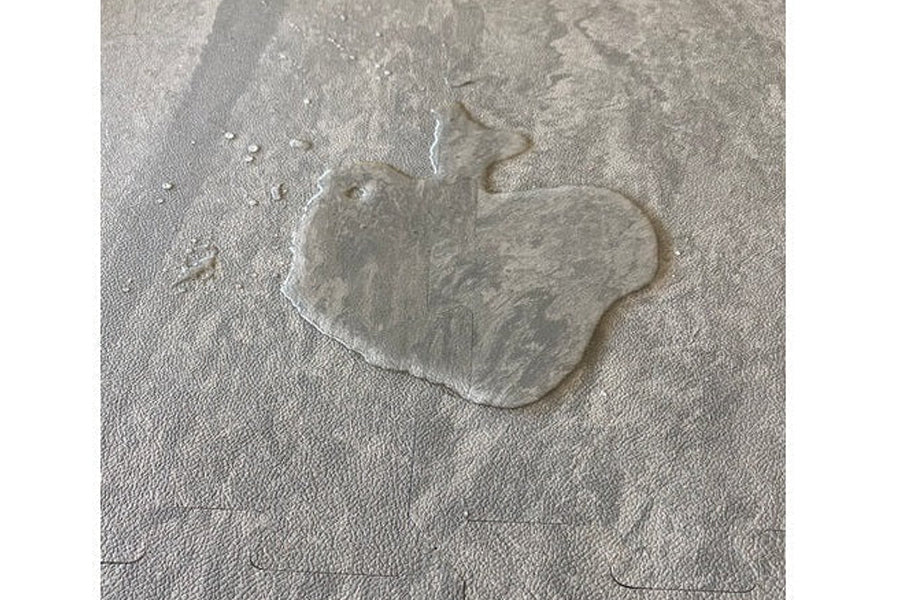 Stone grey interlocking gym tile with embossed warrior head design, shown on flat surface
