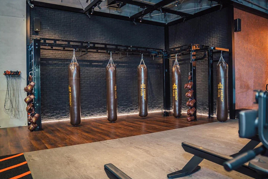 Warrior Marble Interlocking Gym Tile Flooring in taupe installed in boxing gym with heavy bags