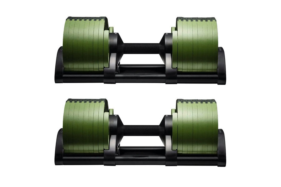 Pair of adjustable dumbbells with green ribbed weight plates and black handles on base, flat lay view