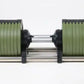 Adjustable dumbbell with sage green plates, black end caps, and silver steel handle on white background