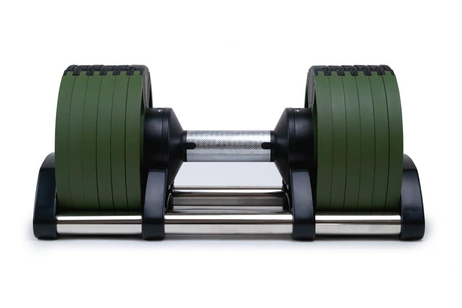 Pair of adjustable dumbbells with green rubber plates and black caps, chrome handle, on white background