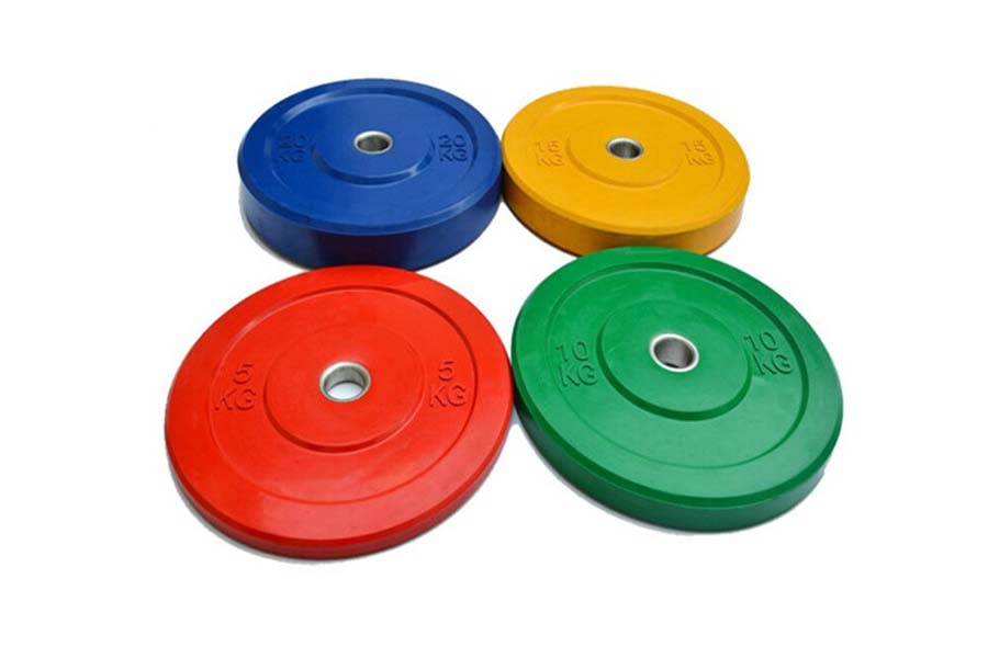 Set of four color-coded rubber bumper plates in blue, yellow, red, and green with weight markings, displayed on white backgro