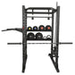 Black power rack with weight plate storage shelves holding colored medicine balls and dumbbells, featuring pull-up bar and ba