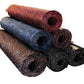 Stacked rubber gym flooring rolls in red, blue, brown, and black speckled colors on white background