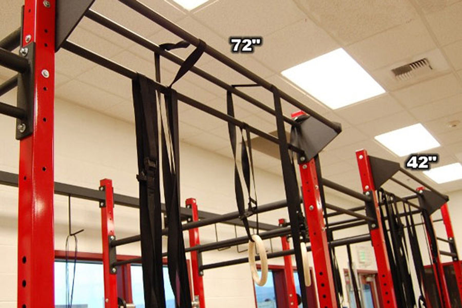Red and black steel pull-up rig with multiple bars and mounting points, labeled 72" and 42" heights, in gym setting