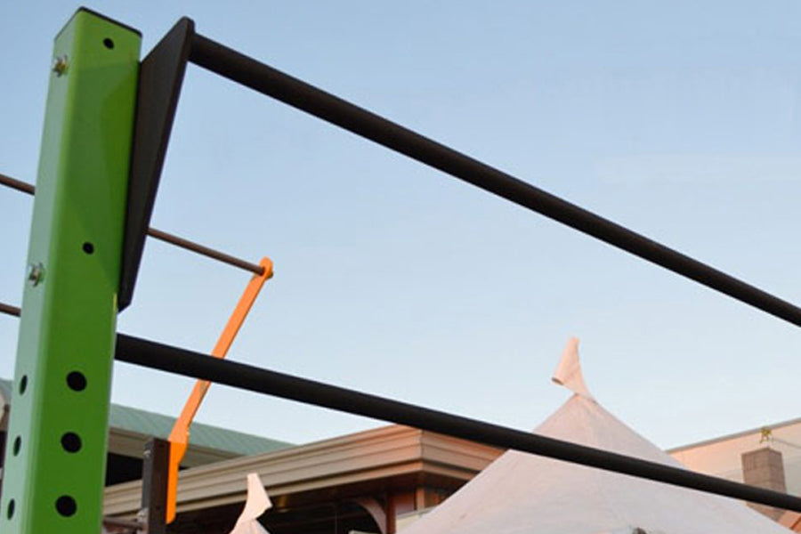 Warrior Two Position Pull Up Bar with green post and black horizontal bars mounted on outdoor structure