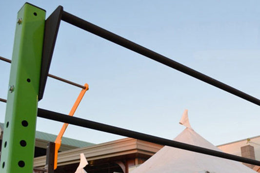 Warrior Two Position Pull Up Bar with green post and black horizontal bars mounted on outdoor structure