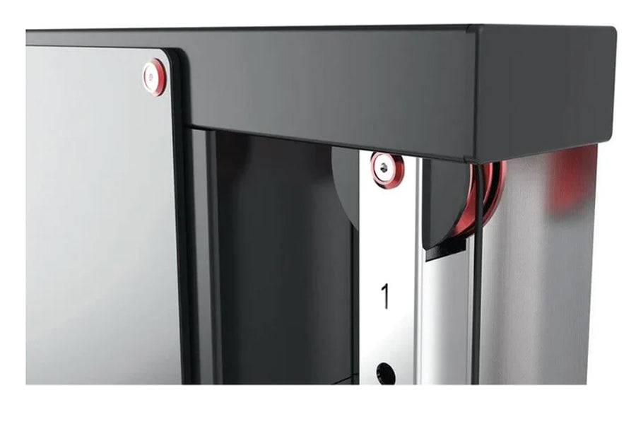 Warrior wall-mounted cable pulley system with black top frame, stainless steel column, and red accent details, shown from sid