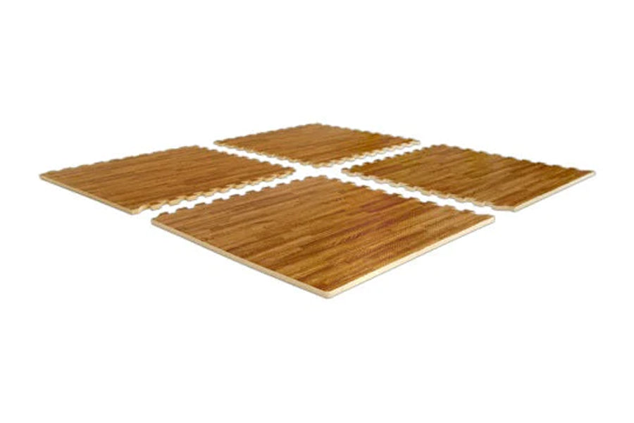 Four interlocking wood grain gym floor tiles in golden brown arranged in a cross pattern on white background