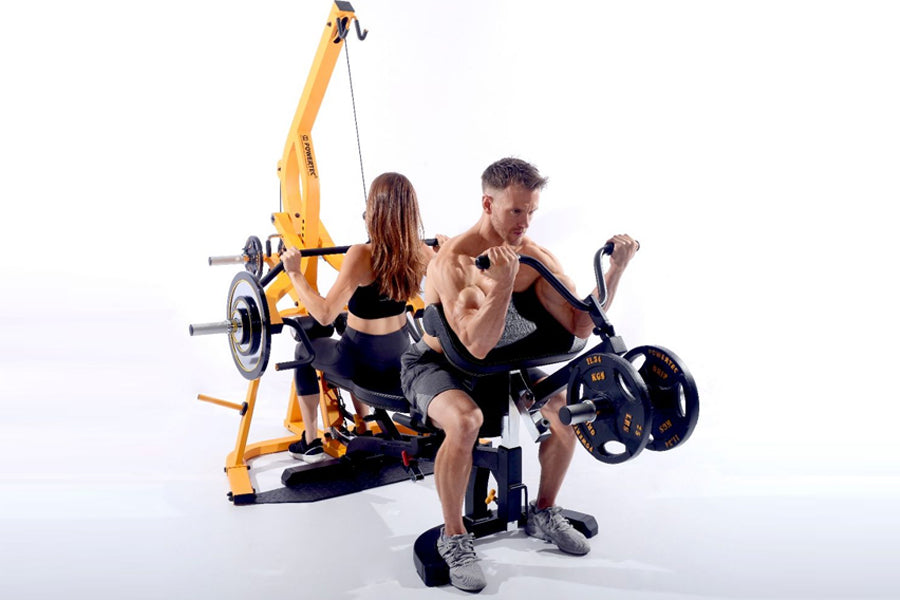Two people using yellow and black Powertec WorkBench multi-station gym equipment with weight plates, demonstrating curl and l