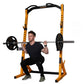 Yellow and black Powertec half rack with adjustable safety arms, shown with model performing barbell squat exercise